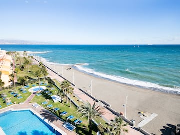 a beach with palm trees and a pool