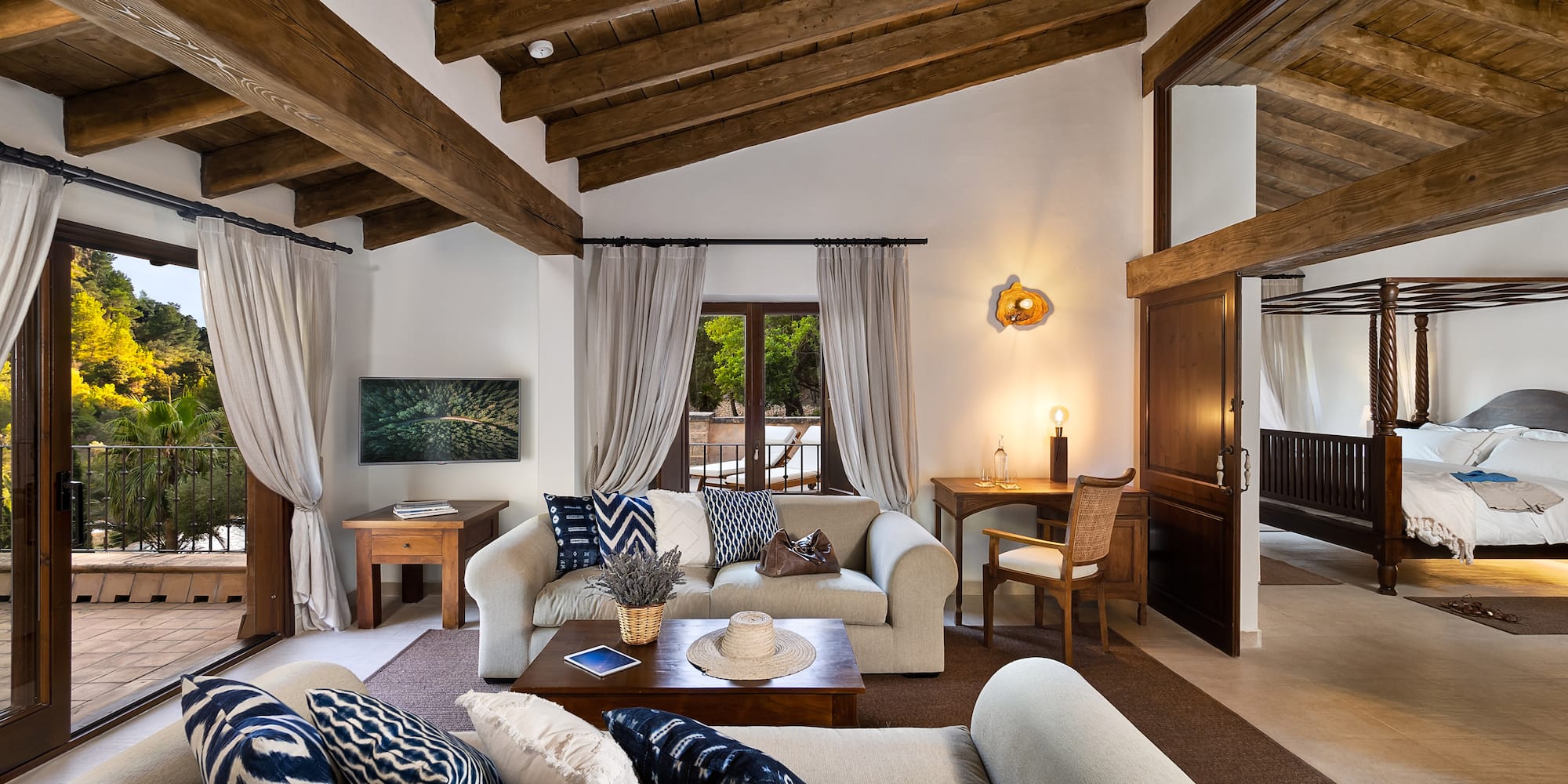 a living room with a wood ceiling and a wood beam