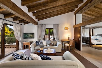 a living room with a wood ceiling and a wood beam