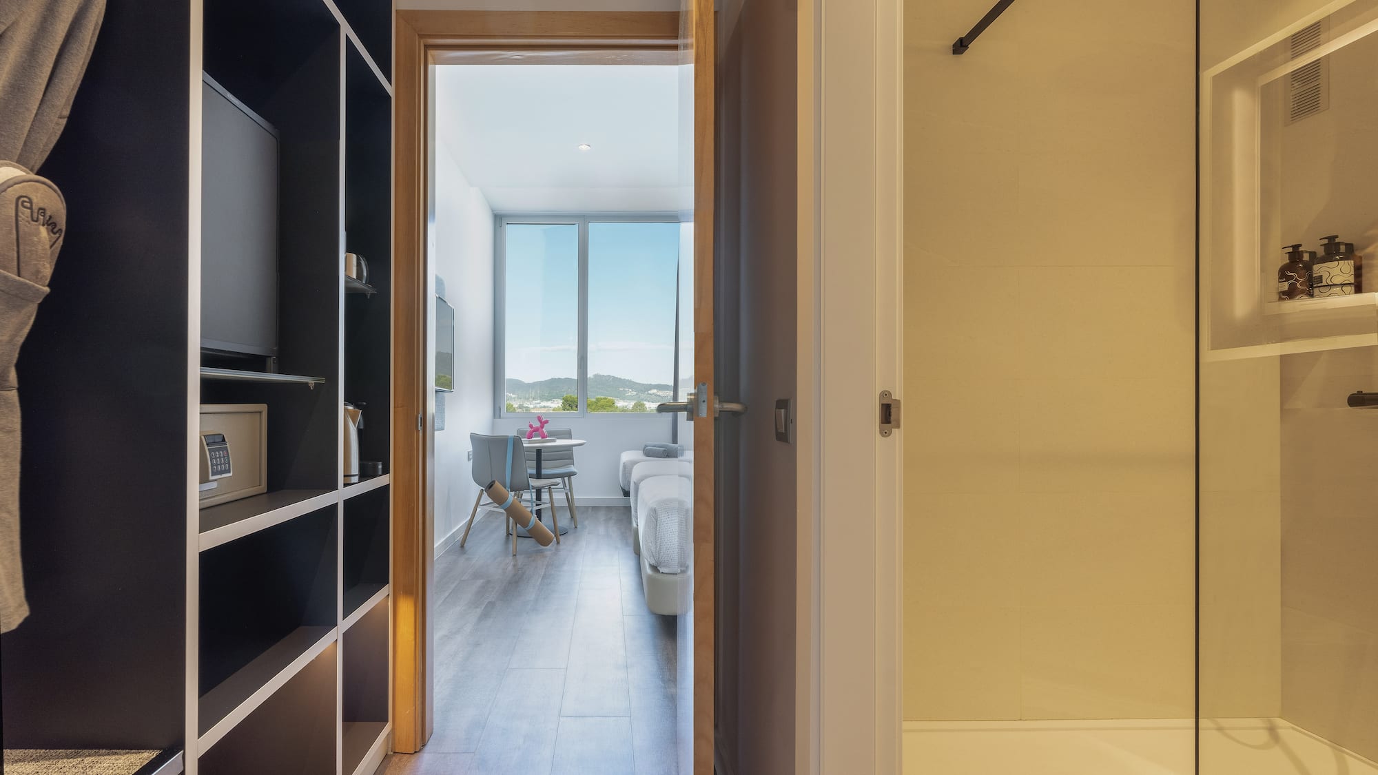 a room with a door open and a bed and a window