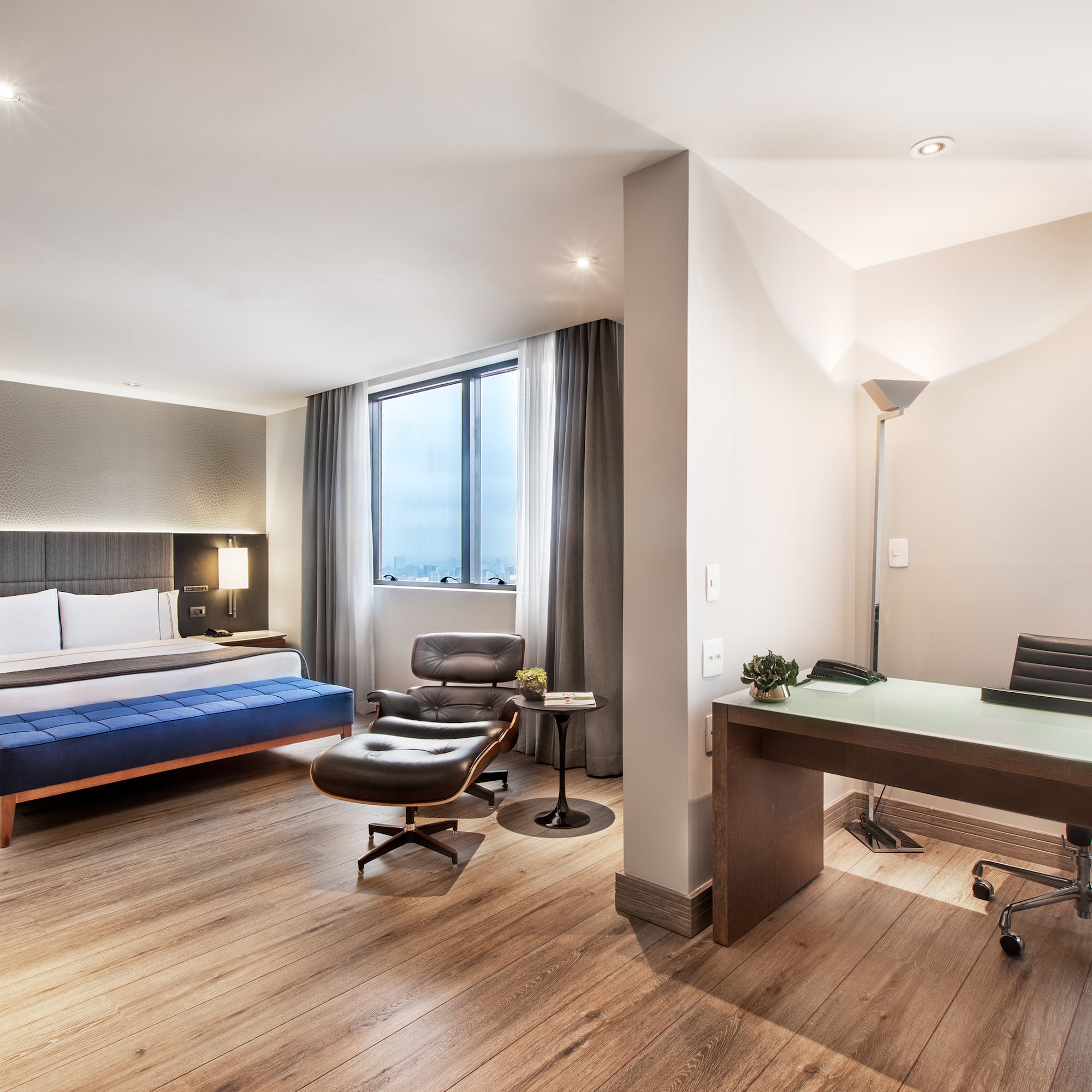 a room with a bed and a desk