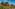 a group of houses with trees in the background