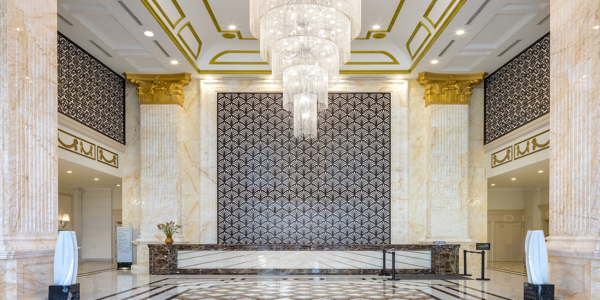 a large room with a chandelier and marble floor