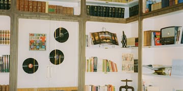 a room with books and a piano