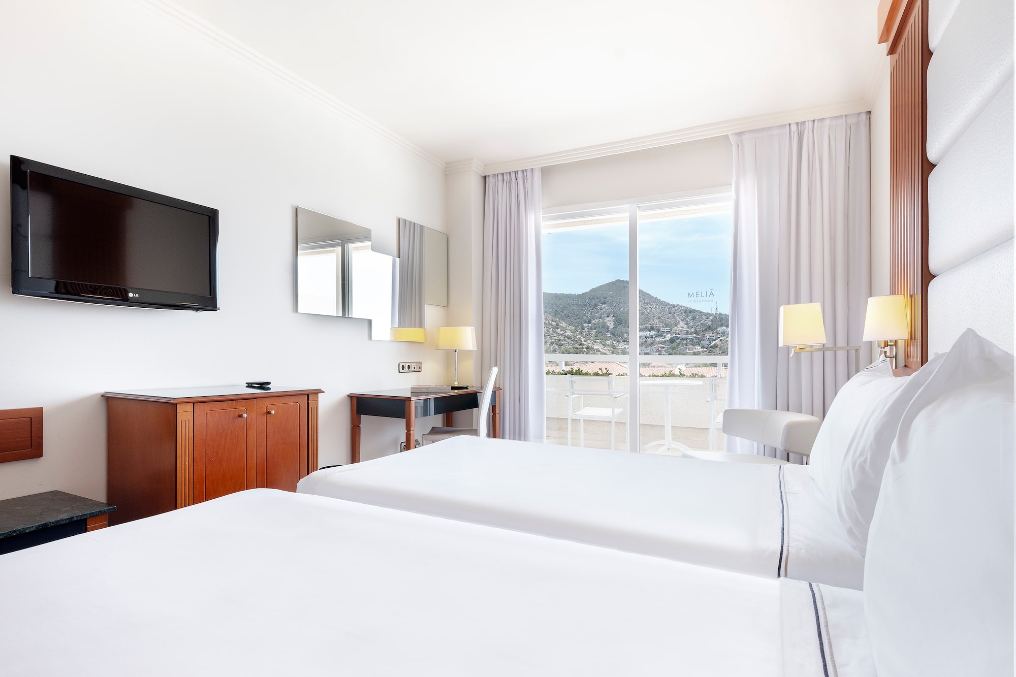 a room with two beds and a television