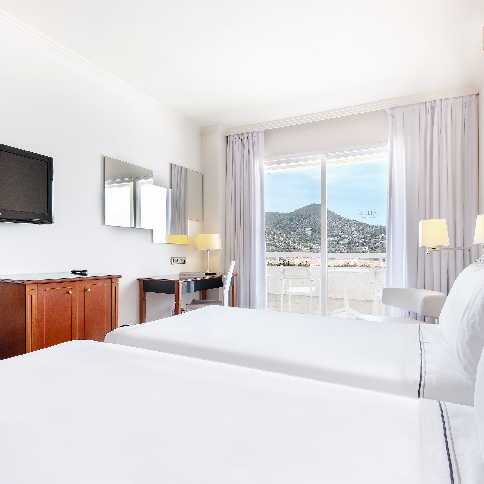 a room with two beds and a television