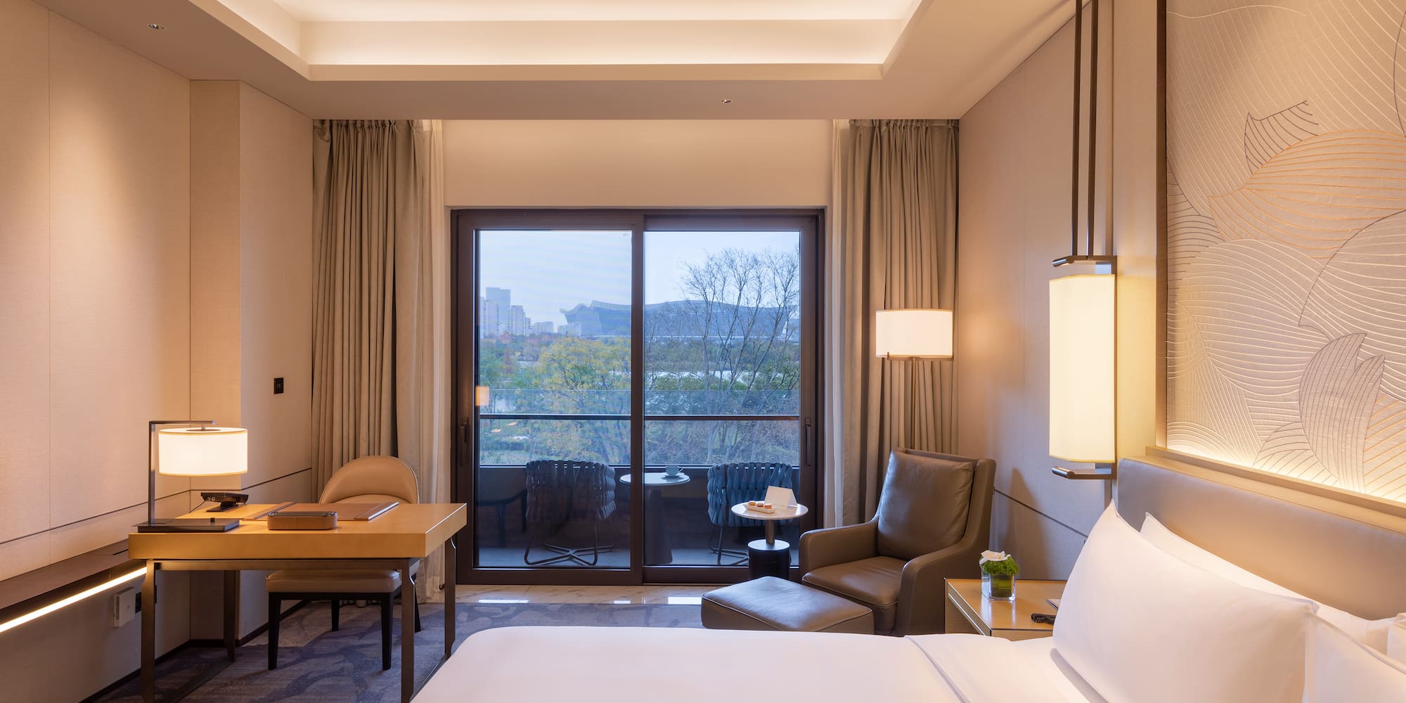 a room with a bed and a table and chairs