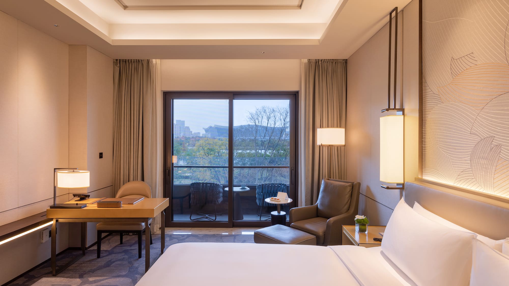 a room with a bed and a table and chairs