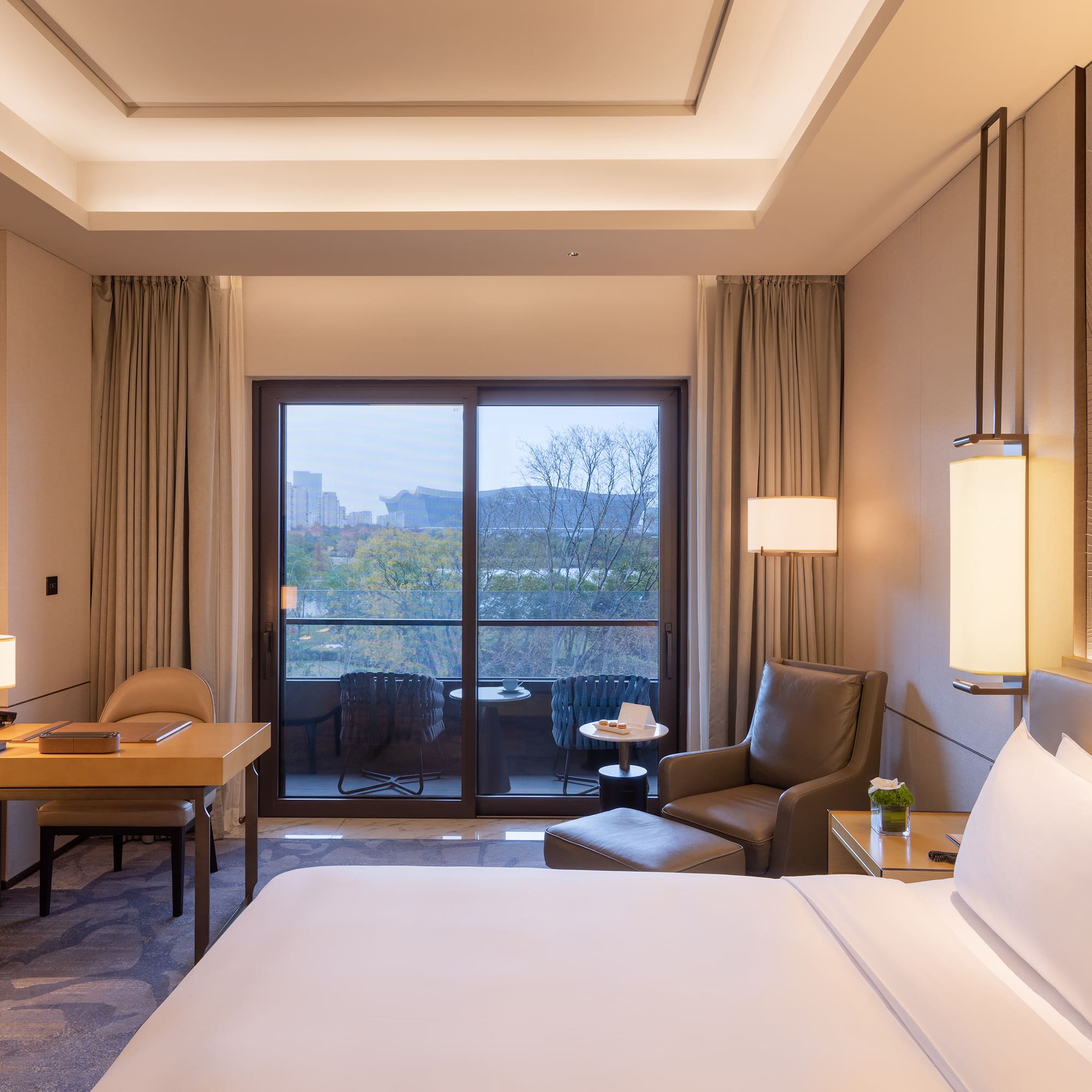 a room with a bed and a table and chairs