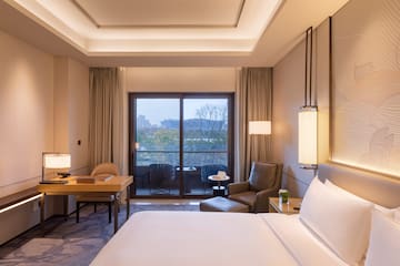 a room with a bed and a table and chairs