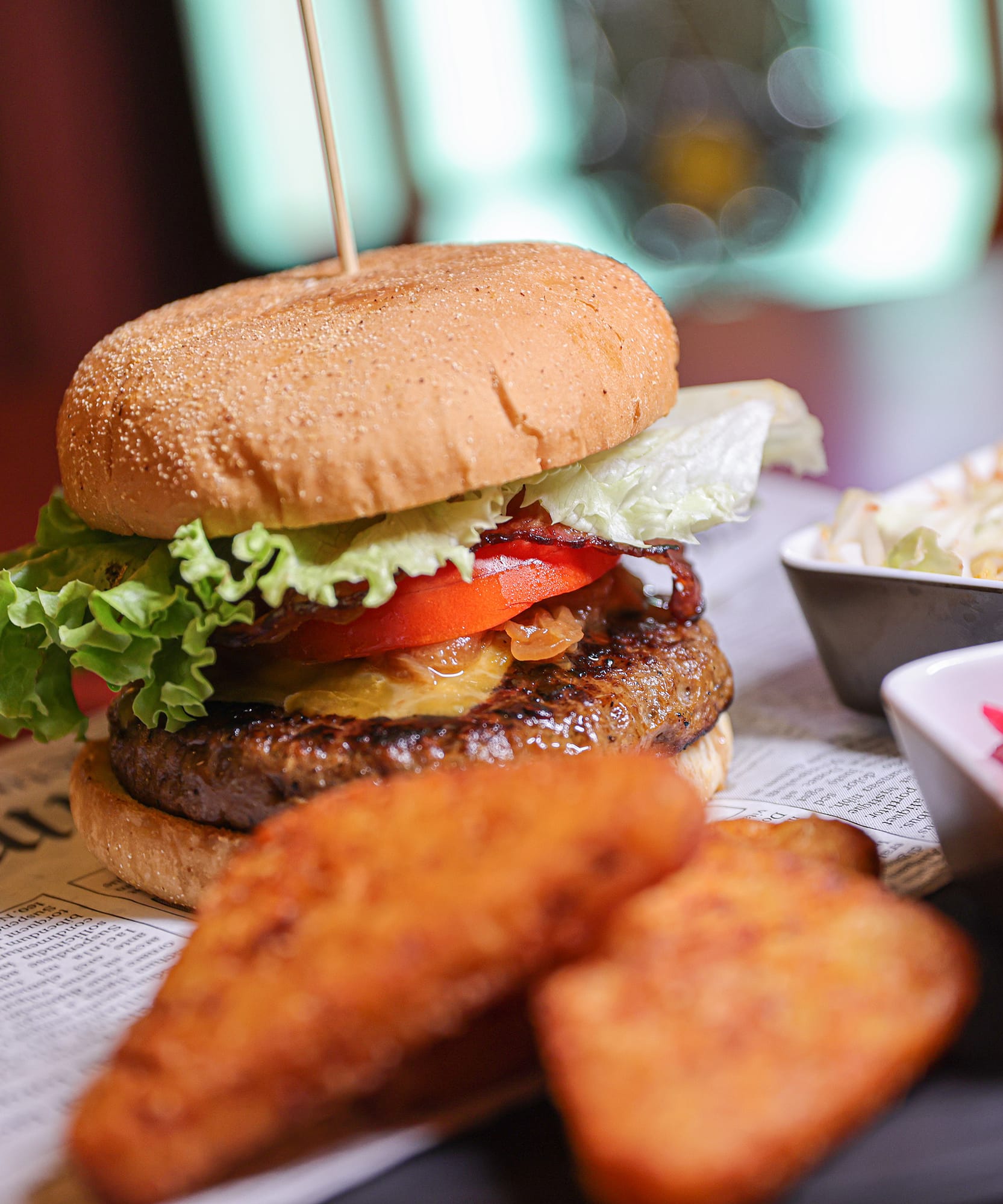 a burger and fries on a newspaper