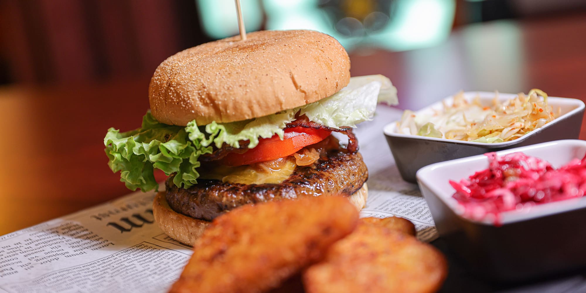 a burger and fries on a newspaper