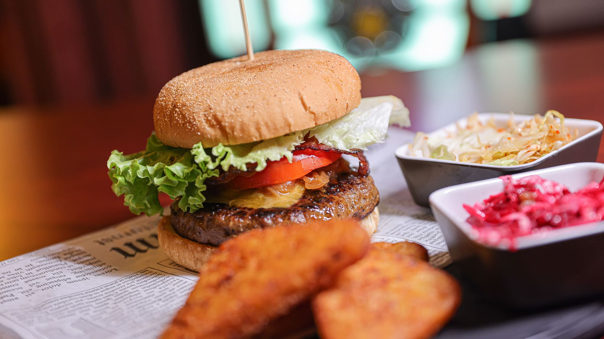 a burger and fries on a newspaper
