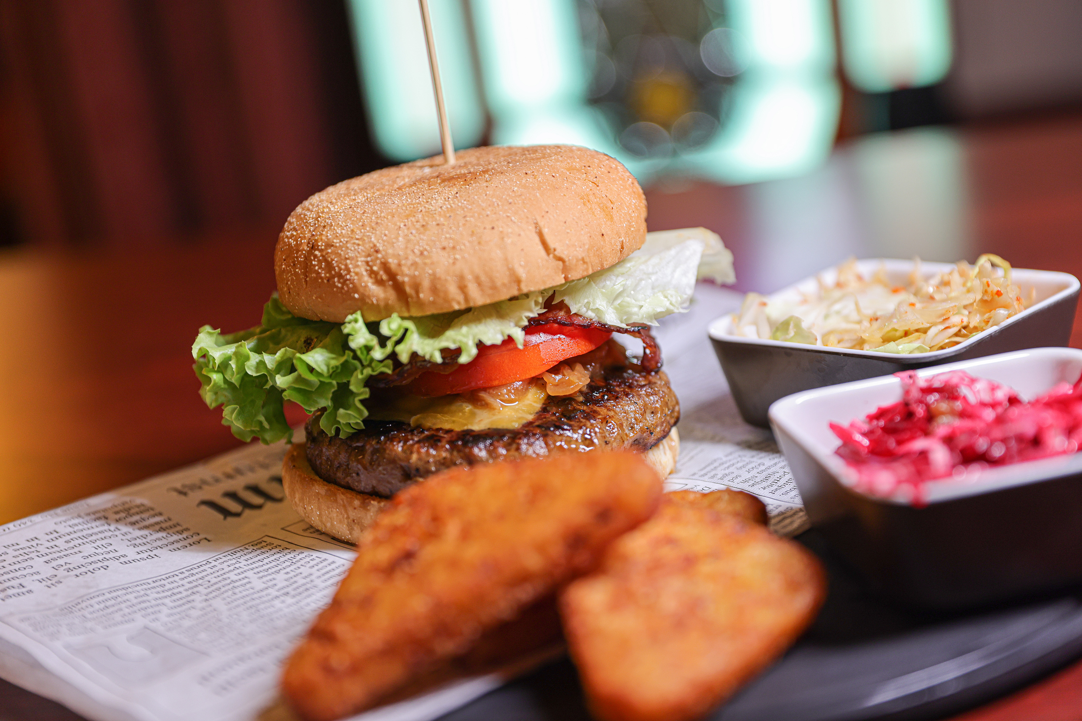 a burger and fries on a newspaper