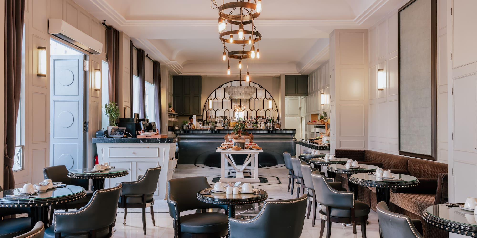 a bar with a chandelier and chairs