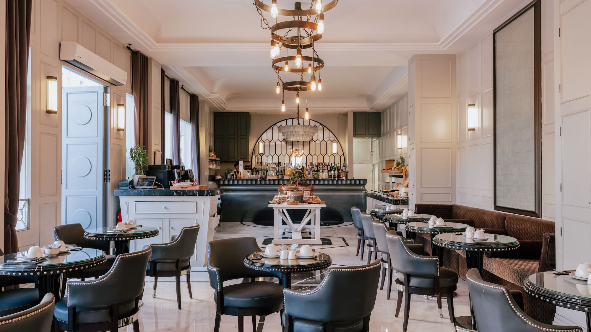 a bar with a chandelier and chairs