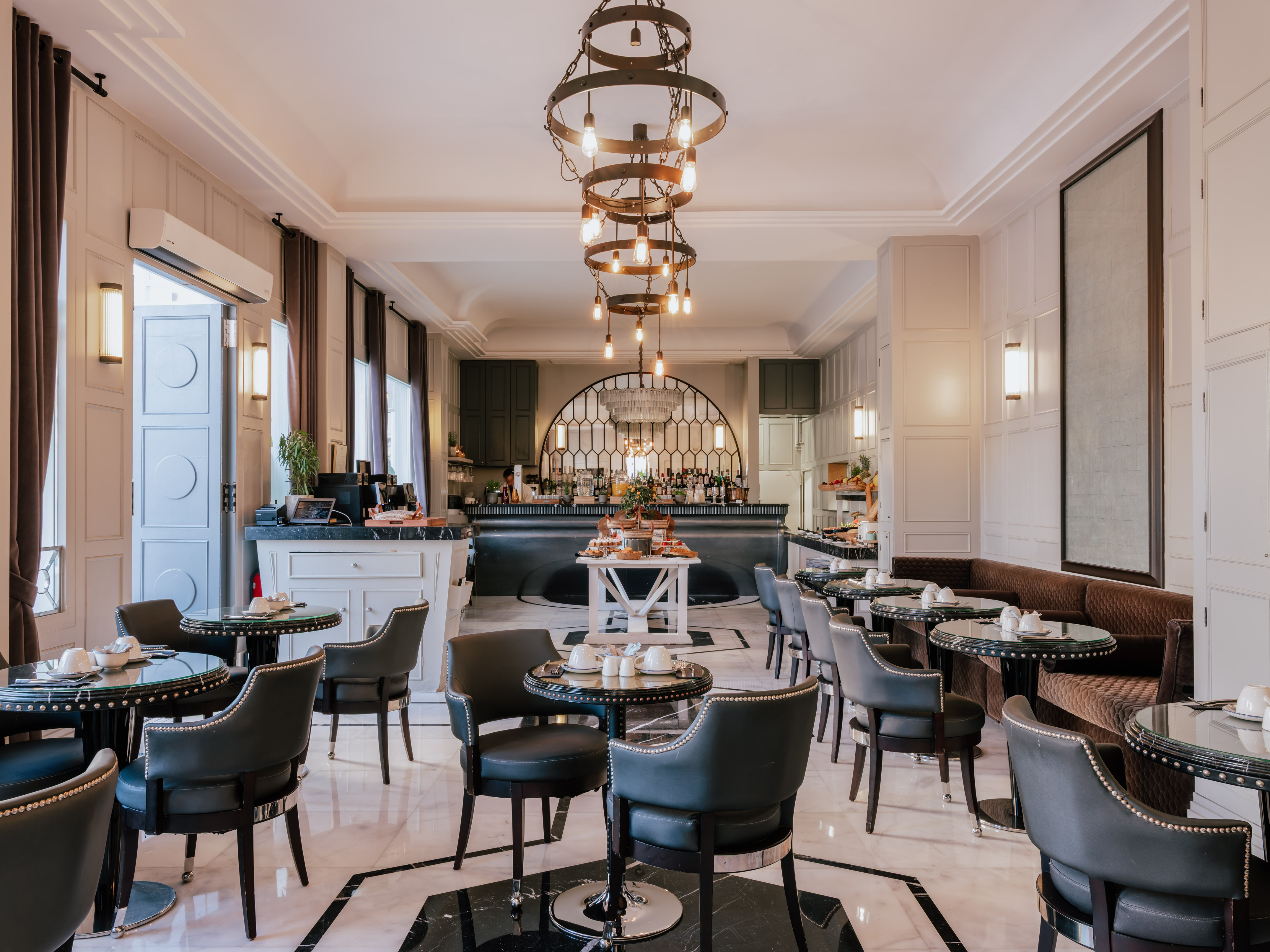 a bar with a chandelier and chairs