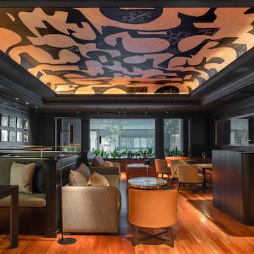 a room with a large ceiling and a large table and chairs