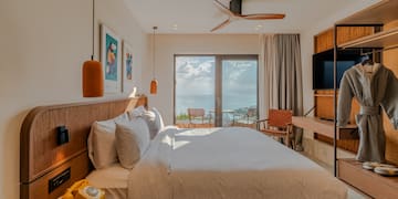 a bedroom with a television and a bed