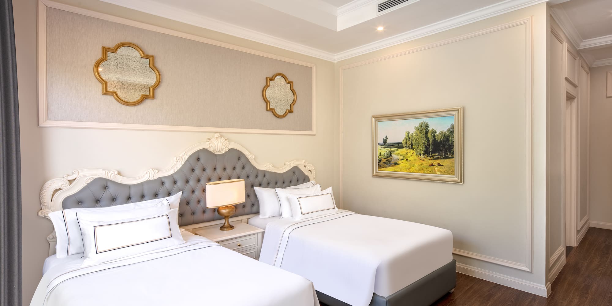 a room with two beds and a picture on the wall