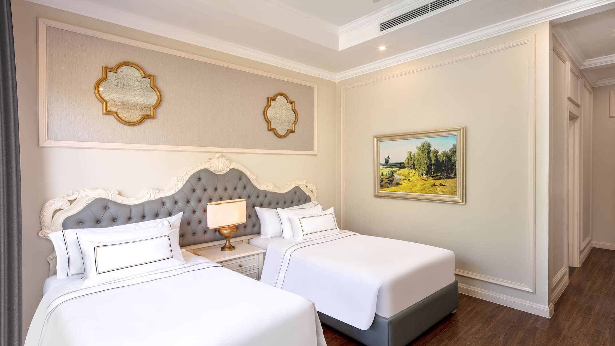 a room with two beds and a picture on the wall