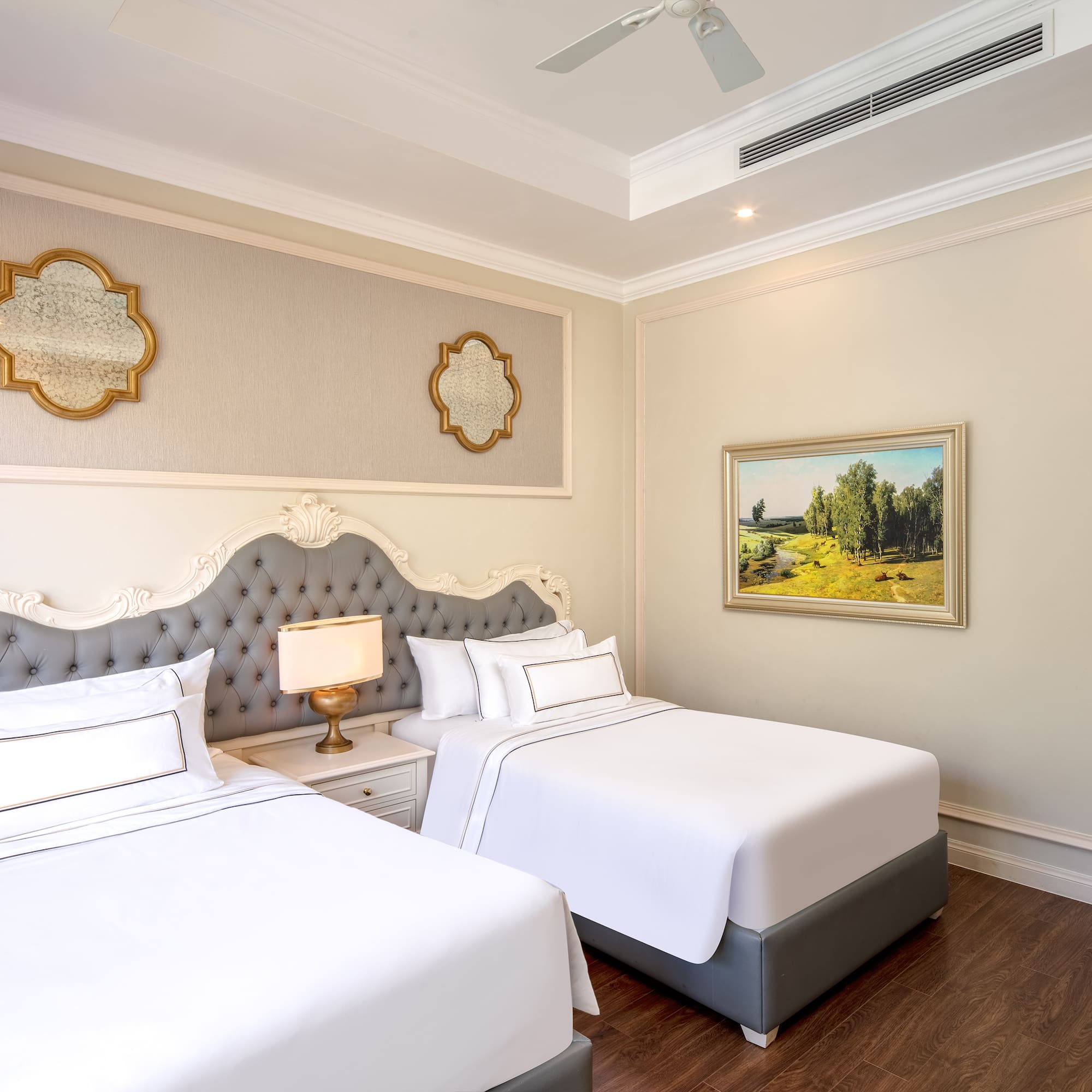 a room with two beds and a picture on the wall