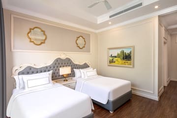 a room with two beds and a picture on the wall