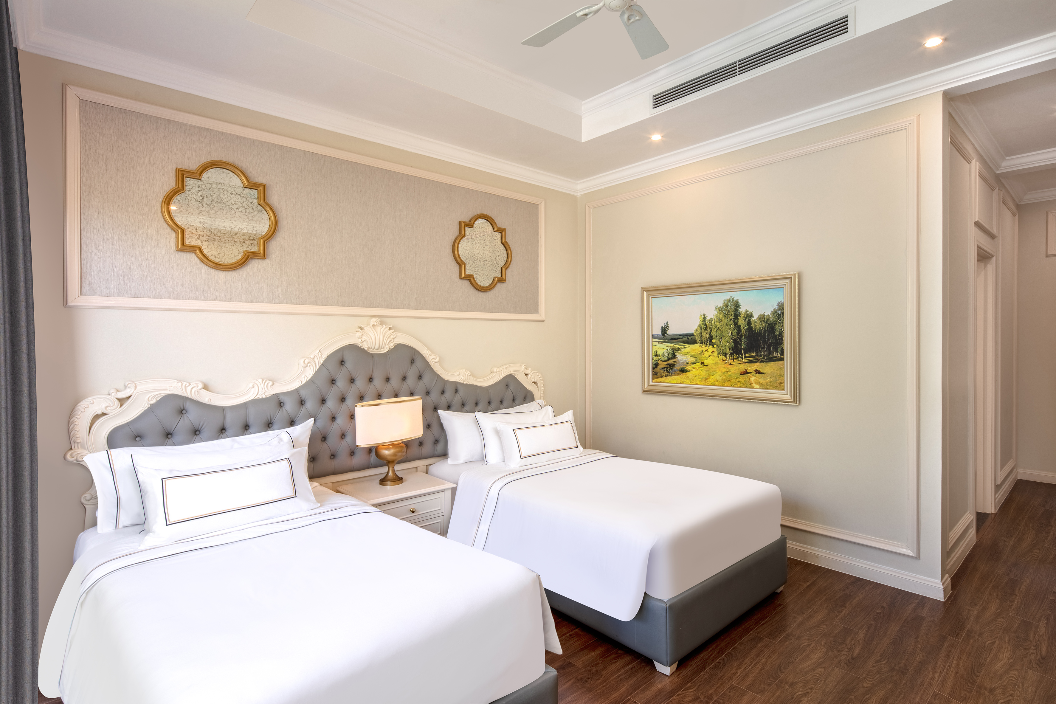 a room with two beds and a picture on the wall