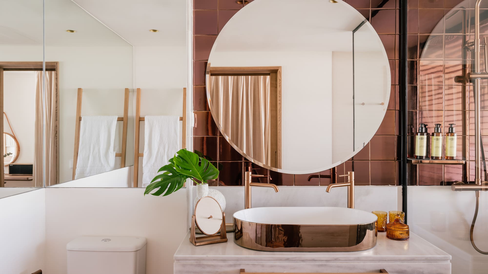 a bathroom with a round mirror and a sink