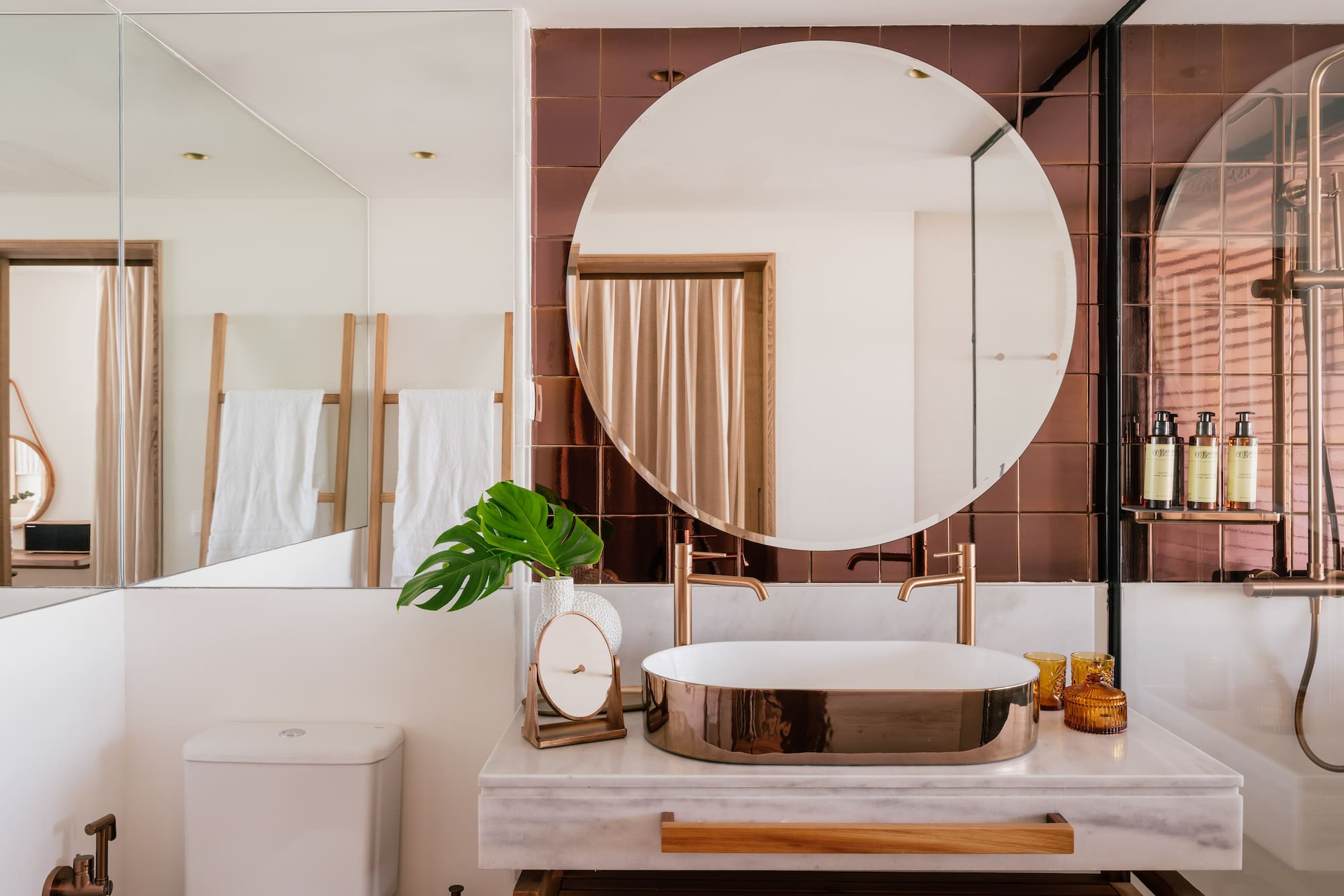 a bathroom with a round mirror and a sink
