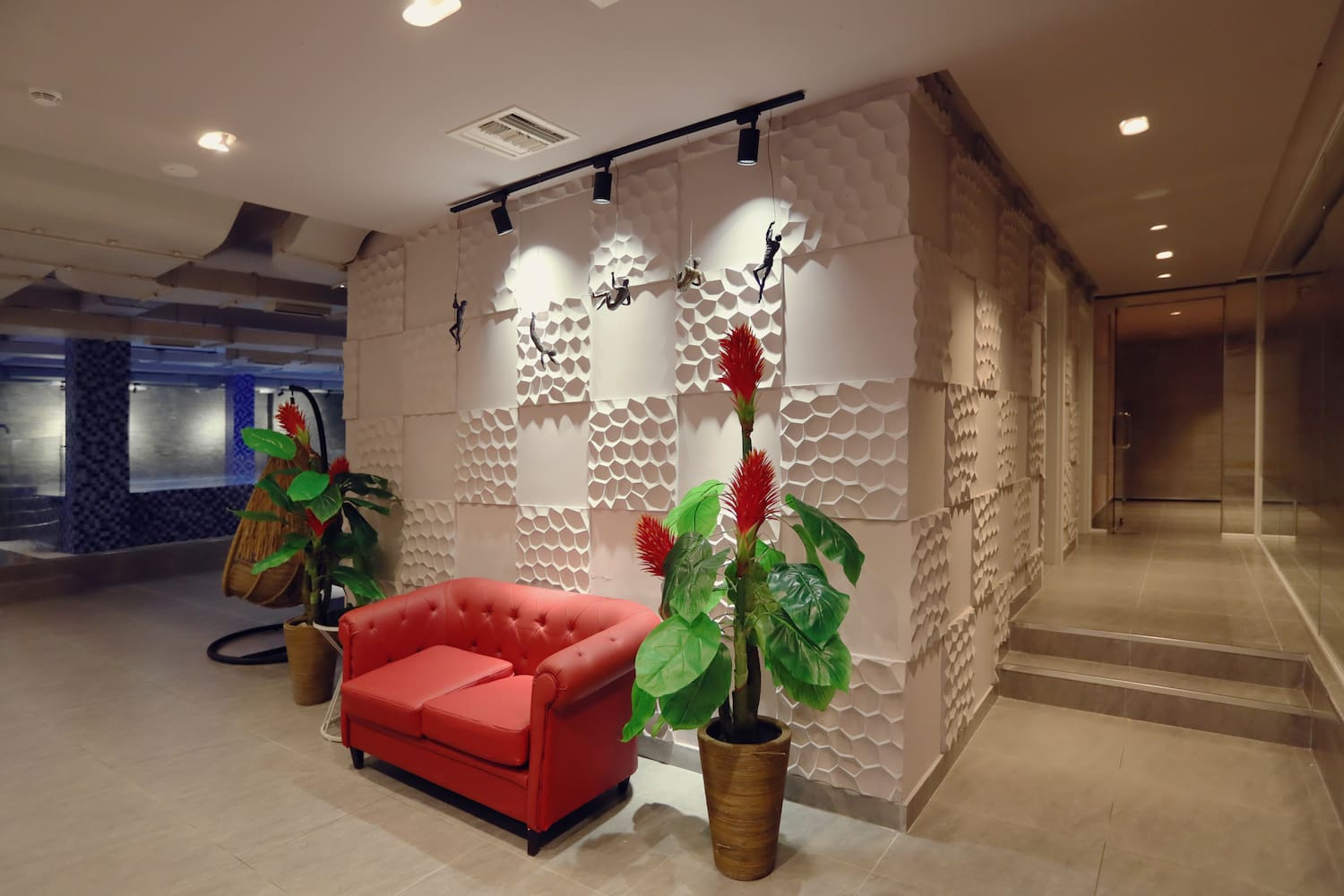 a red couch and plants in a room