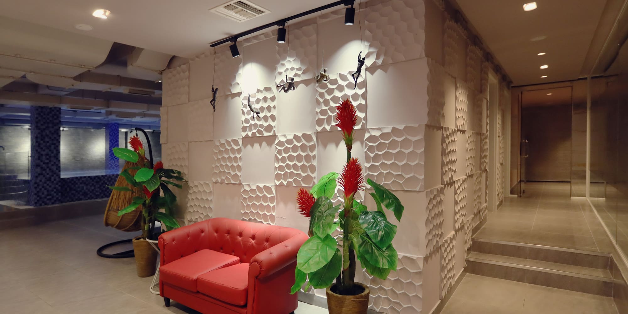 a red couch and plants in a room