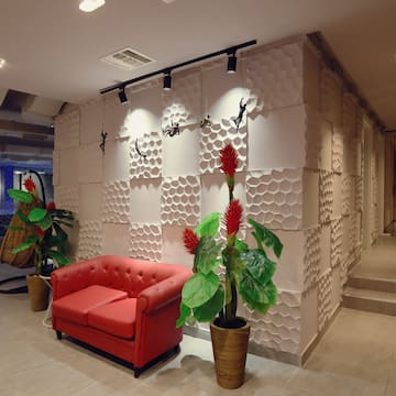 a red couch and plants in a room