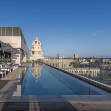 a pool with a large building in the background