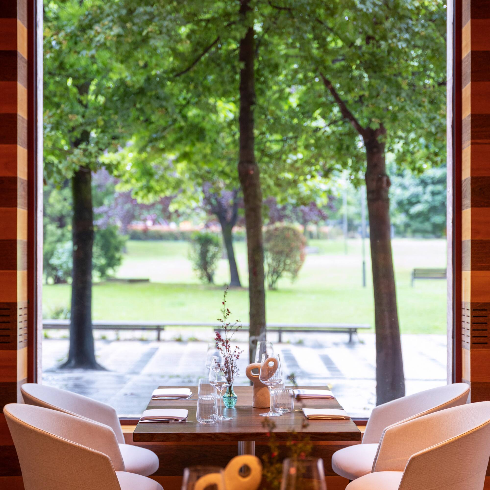 a table with chairs and a large window