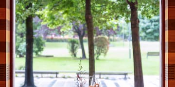 a table with chairs and a large window