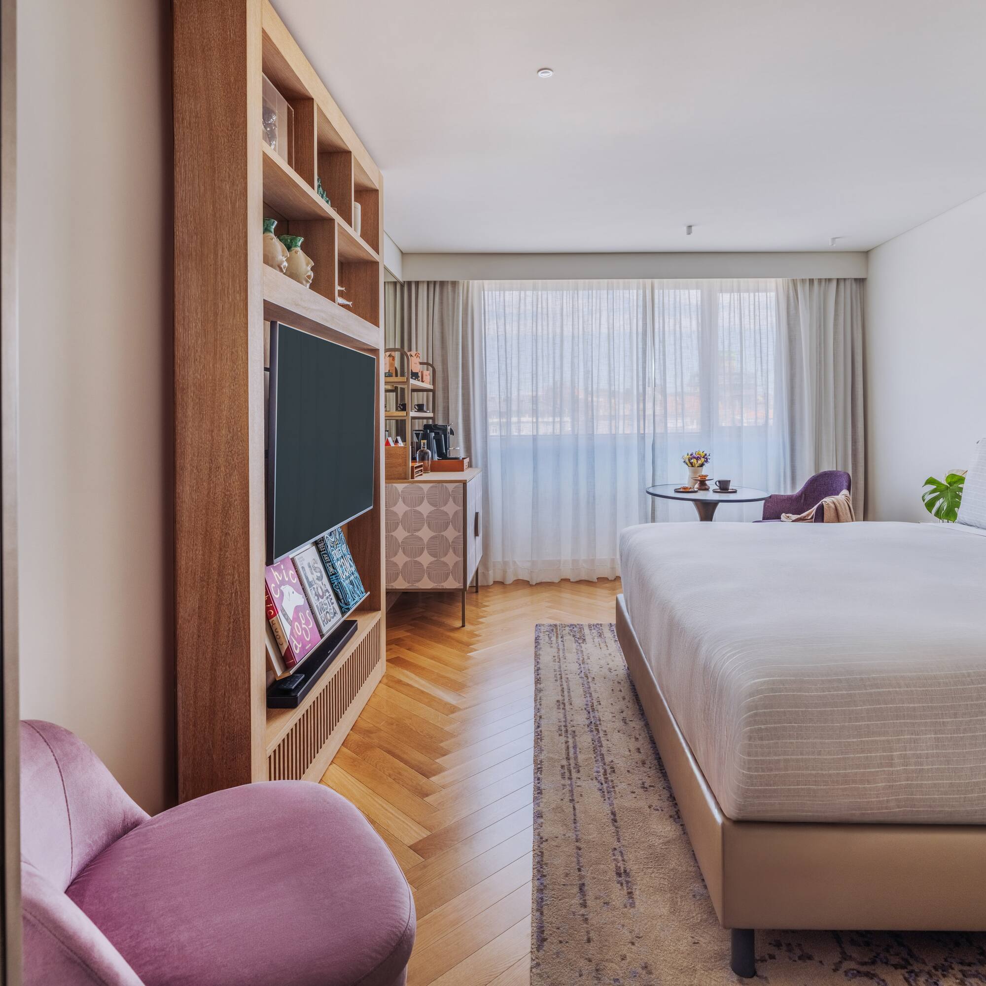 a bedroom with a bed and a tv