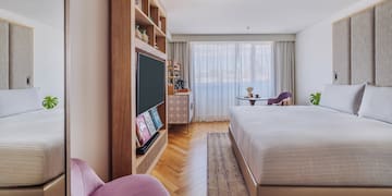 a bedroom with a bed and a tv