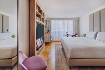 a bedroom with a bed and a tv