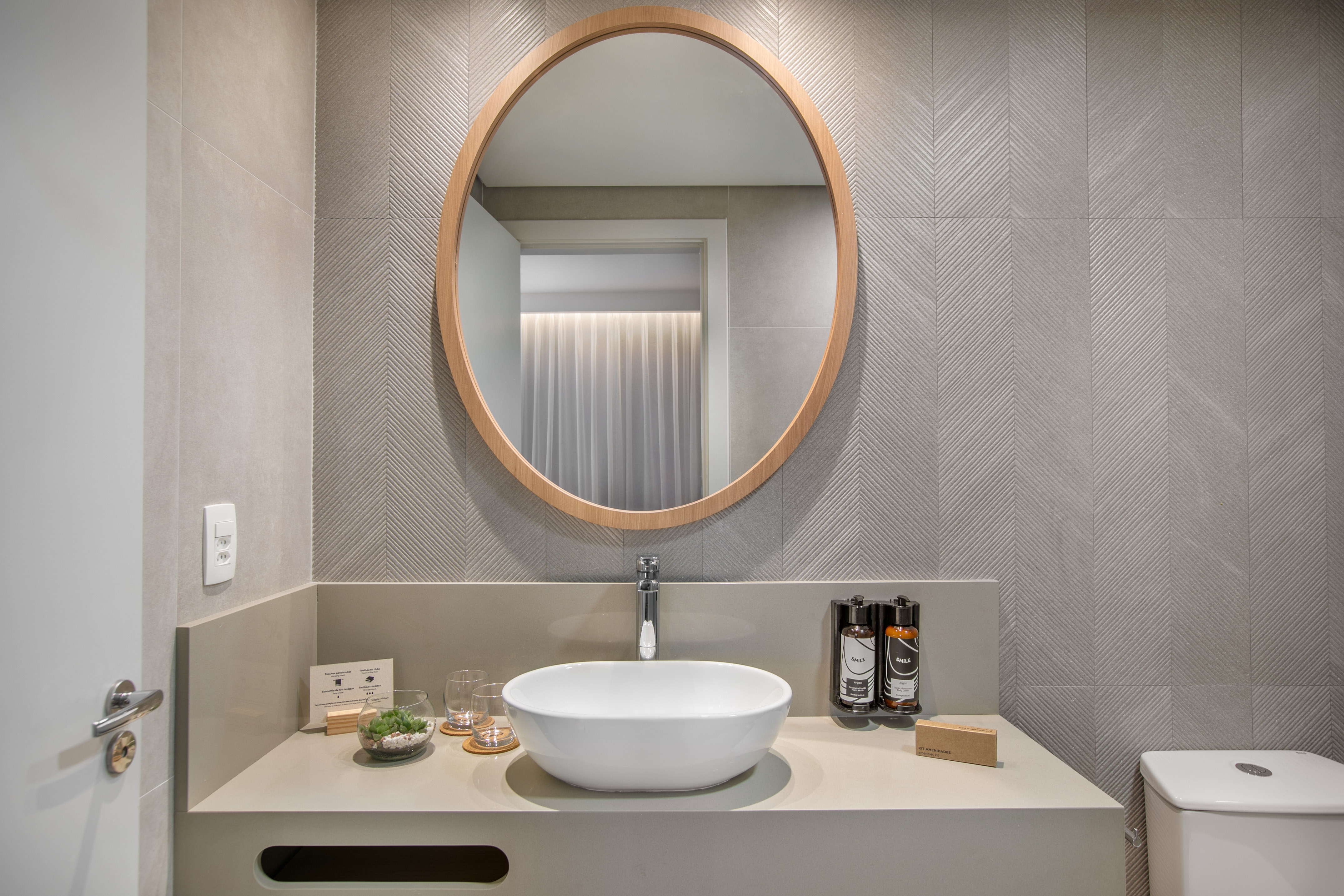 Modern grey bathroom vanity, oval mirror, vessel sink, chevron tiles. - The INNSiDE Premium Room Vista Ciudad - INNSiDE São Paulo Higienópolis, Sao Paulo