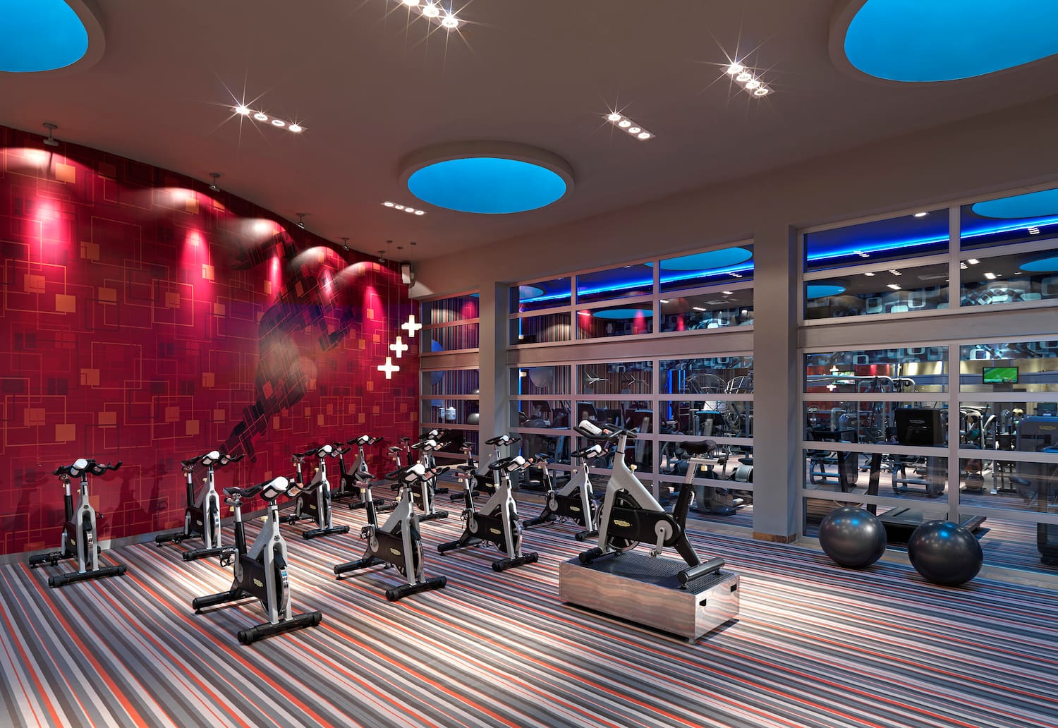 a room with exercise bikes and a large window