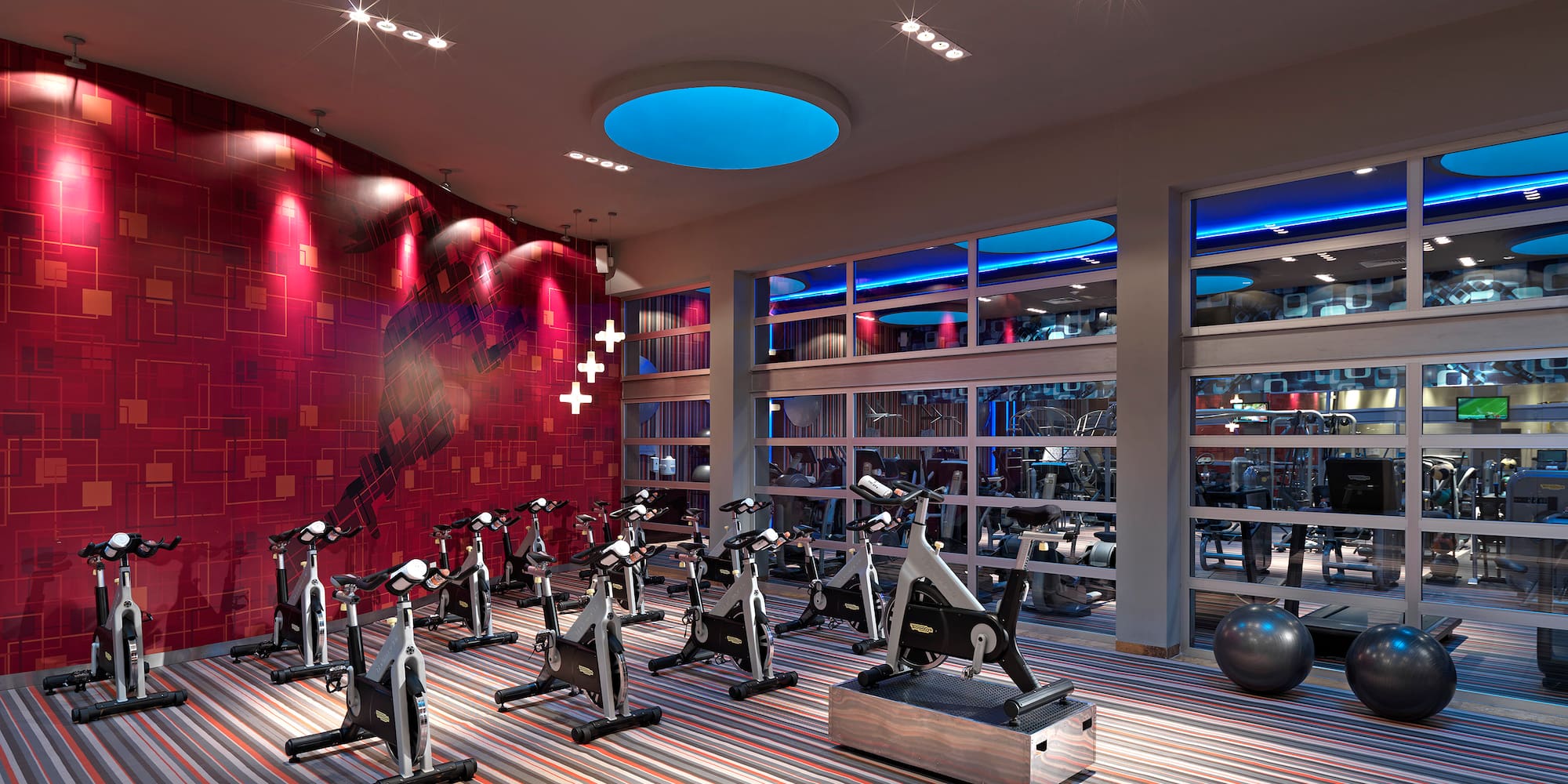 a room with exercise bikes and a large window