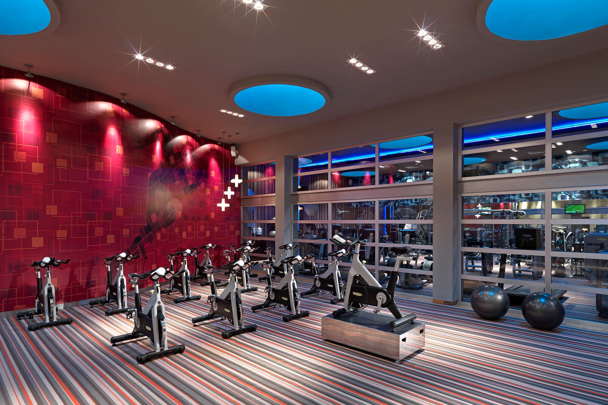 a room with exercise bikes and a large window
