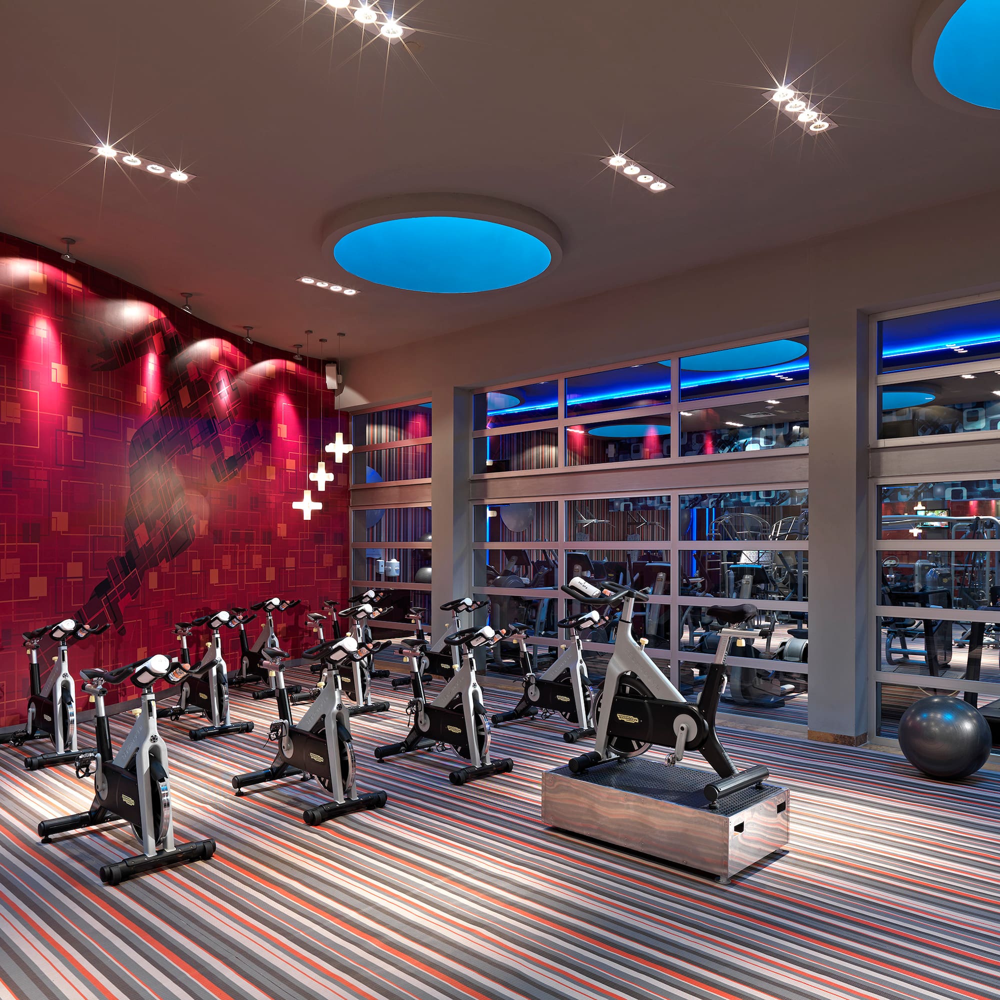a room with exercise bikes and a large window