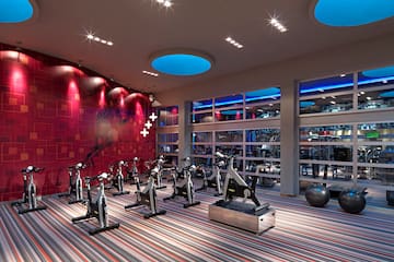 a room with exercise bikes and a large window