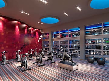 a room with exercise bikes and a large window