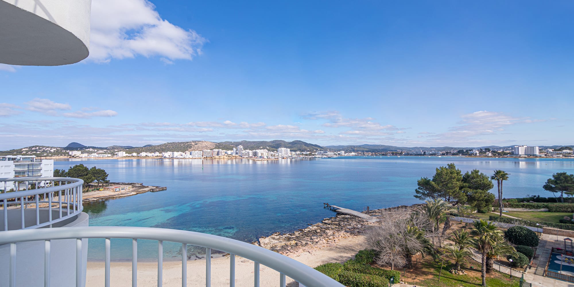 a view of a beach and water from a balcony