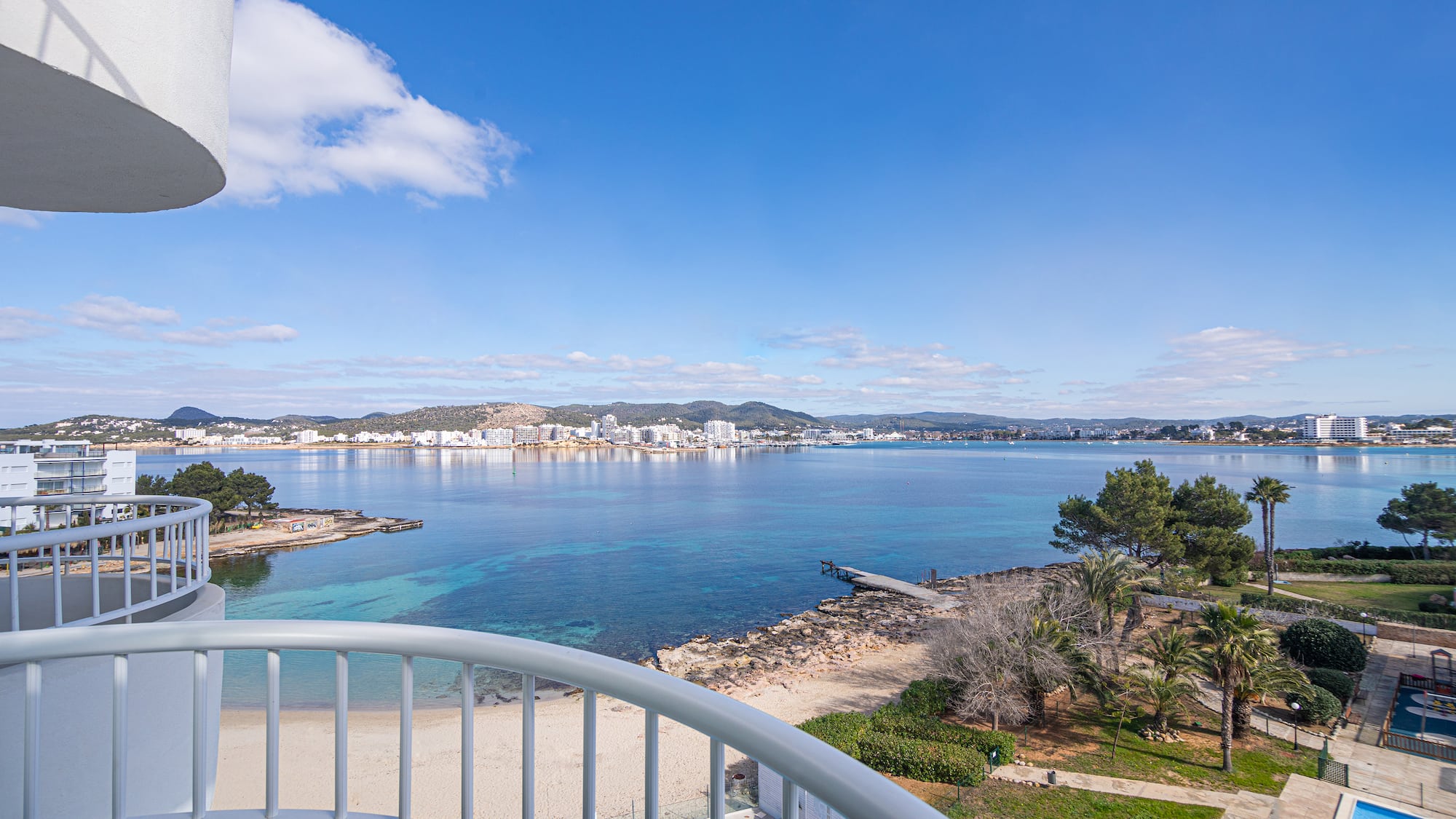 a view of a beach and water from a balcony