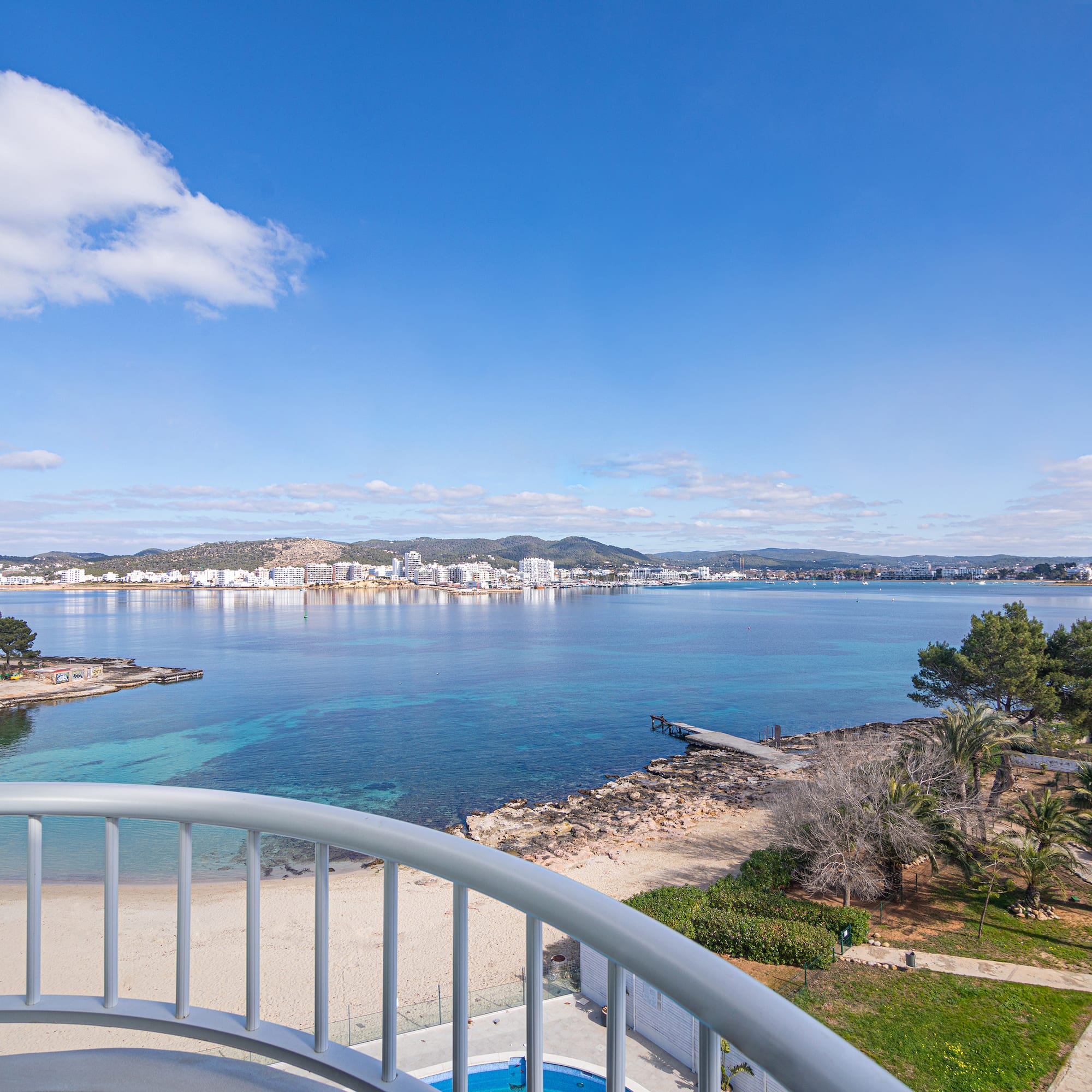 a view of a beach and water from a balcony