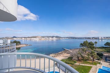 a view of a beach and water from a balcony